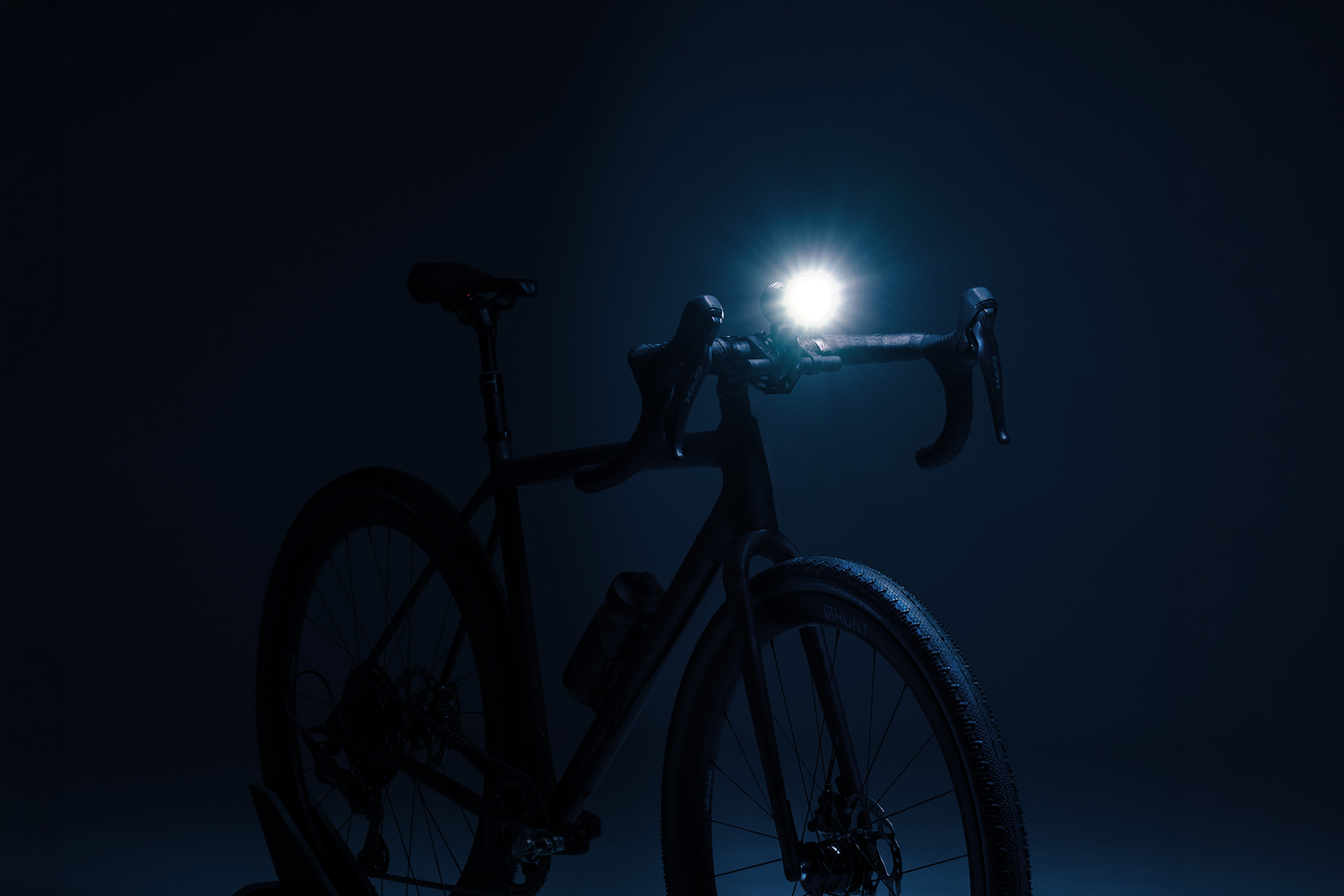Bike stationary with bright light mounted on bars.